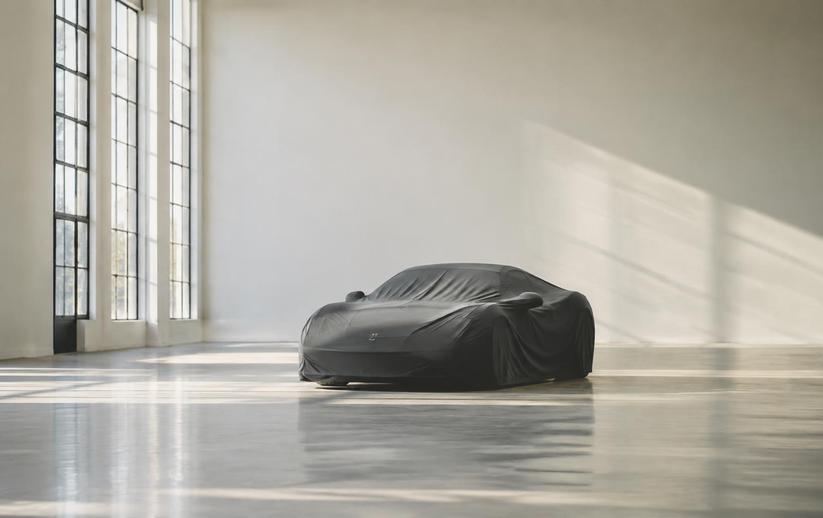 A collector car photographed in profile against concrete architecture